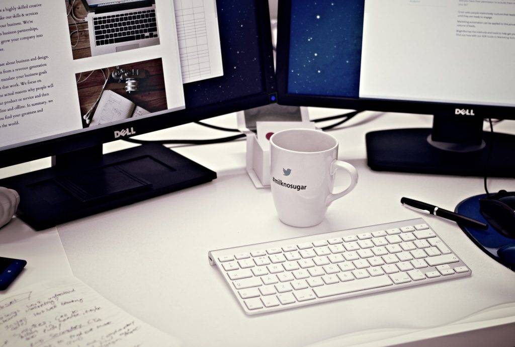 Computer desk with keyboard and coffee mug
